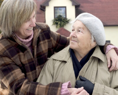 Daughter hugging her mother and smiling to her.